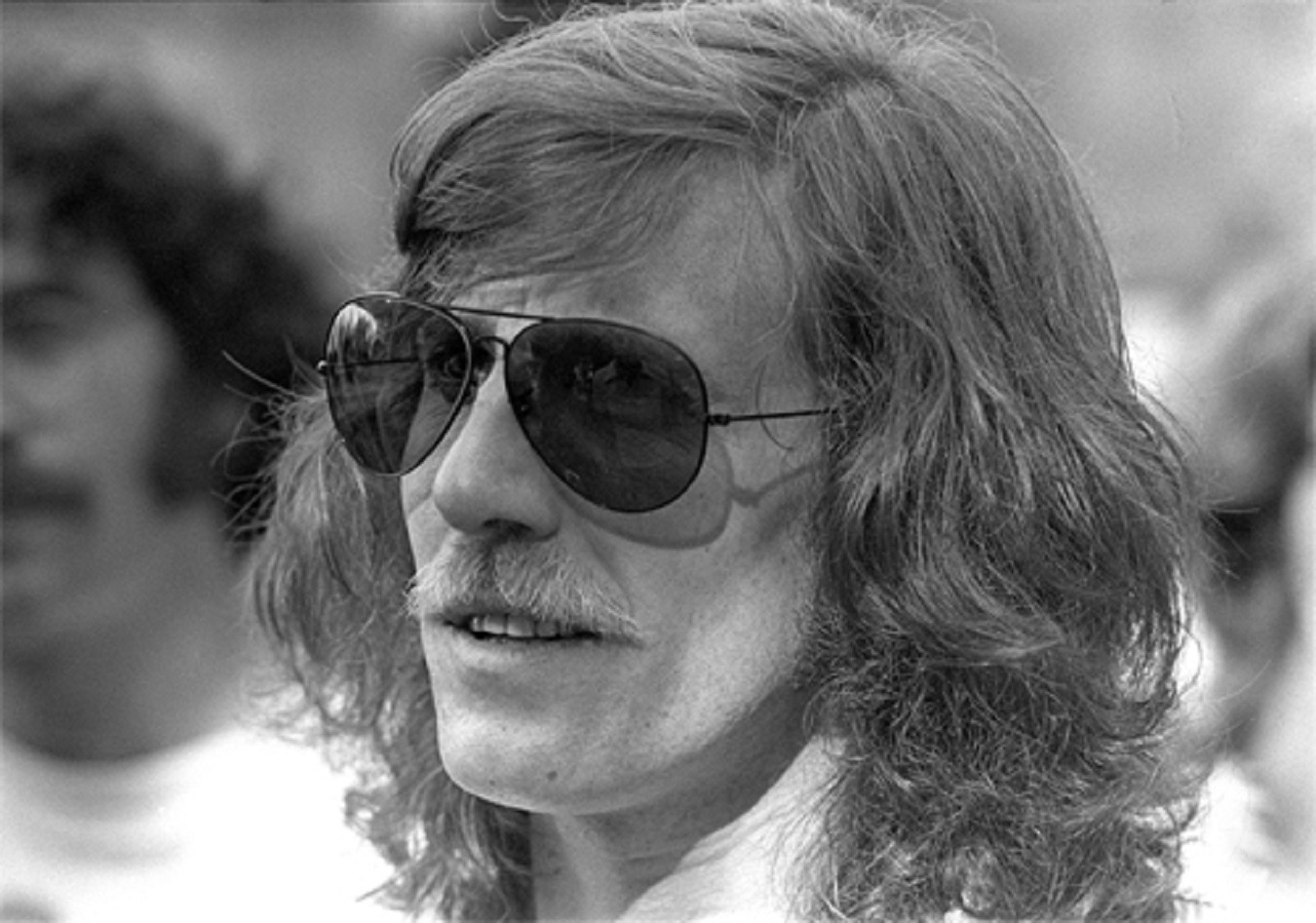 B&W photo of Graham Nash wearing glasses and looking at side - 1976