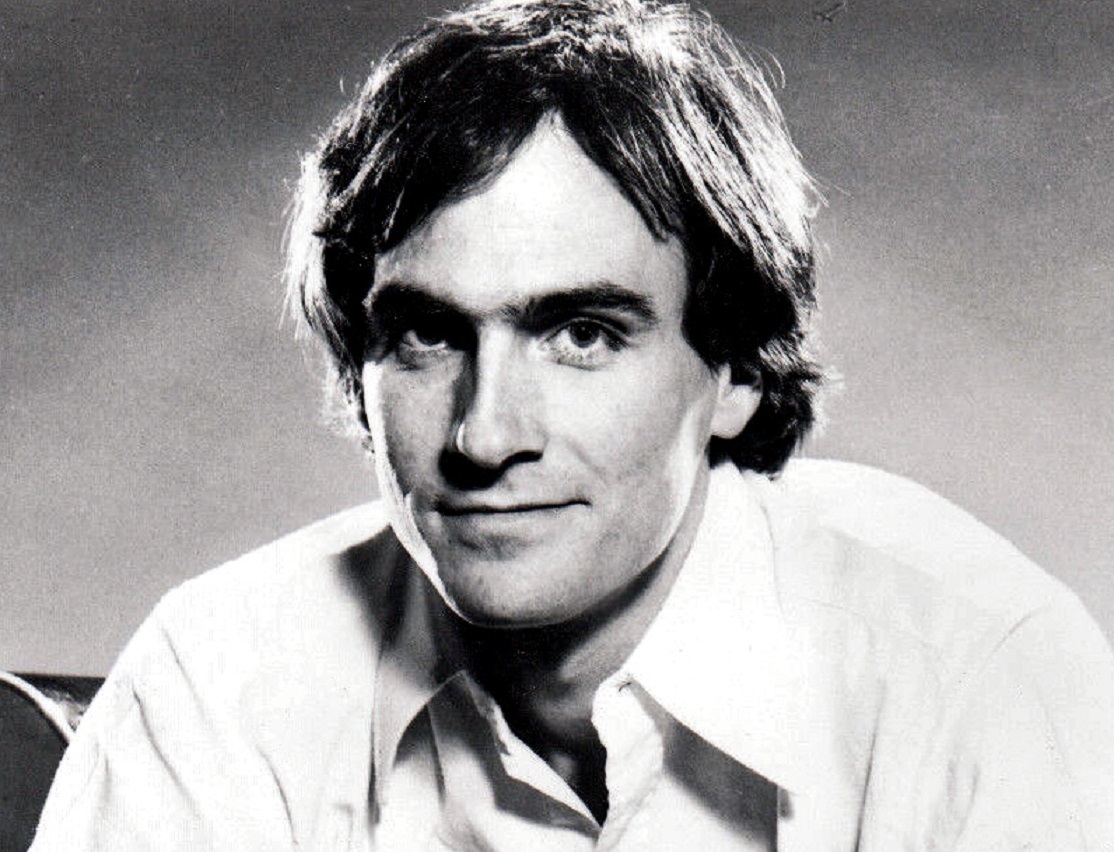 B&W photo of James Taylor is smiling at camera - 1970s