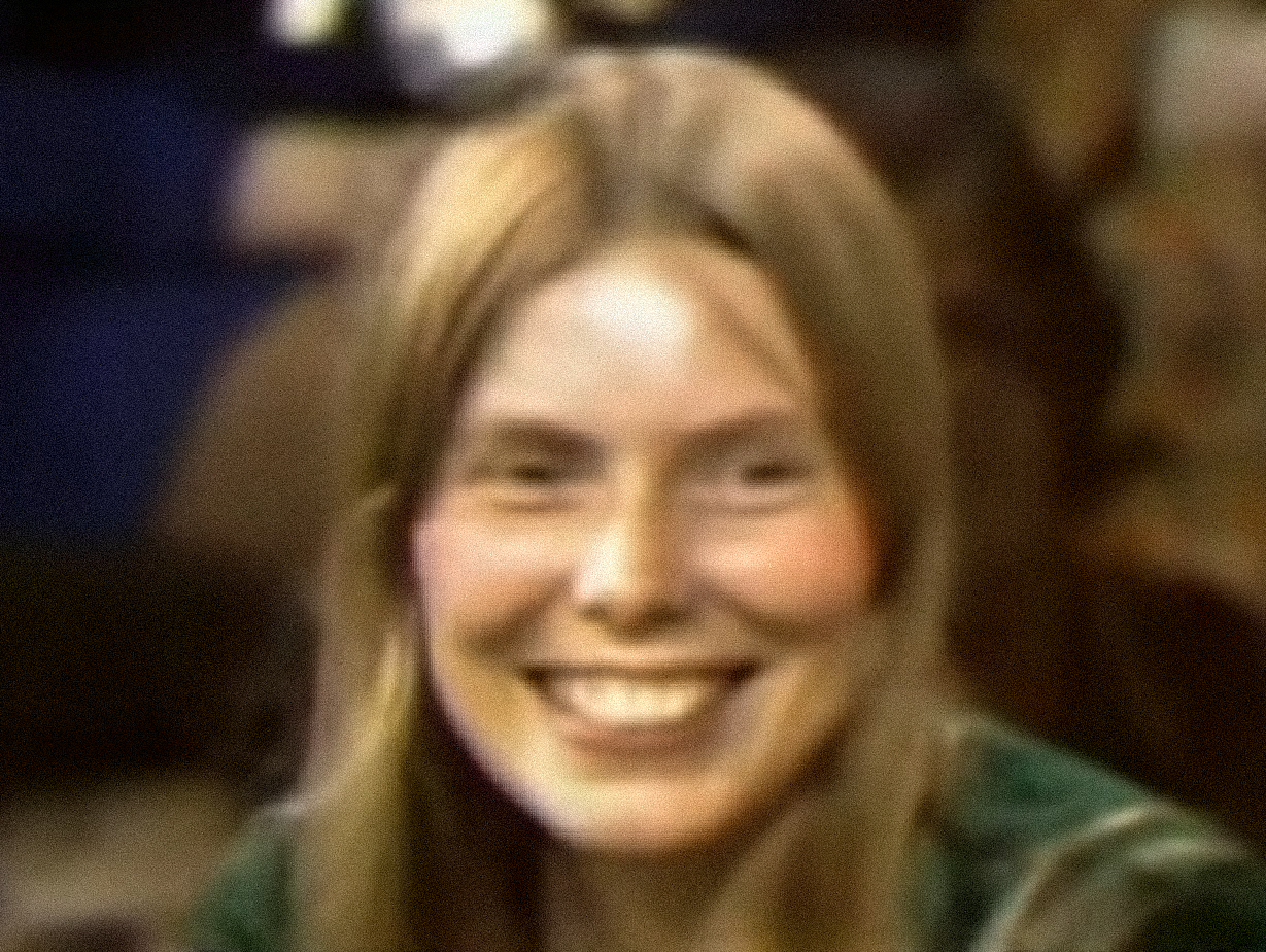 Screenshot: Joni Mitchell is looking at side and smiling - from Joni Mitchell: A Woman of Heart and Mind (2003)
