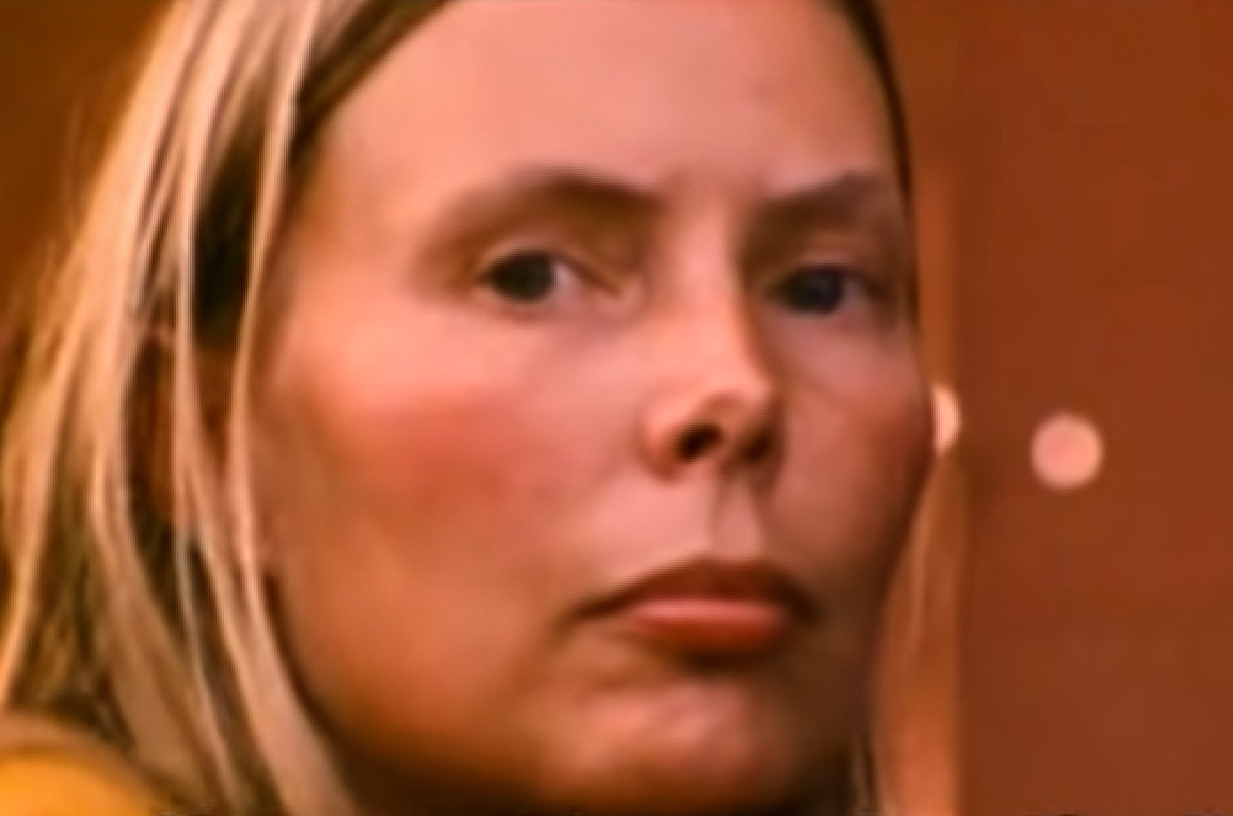 Screenshot: Joni Mitchell is looking at camera with sad face - from Joni Mitchell: A Woman of Heart and Mind (2003)