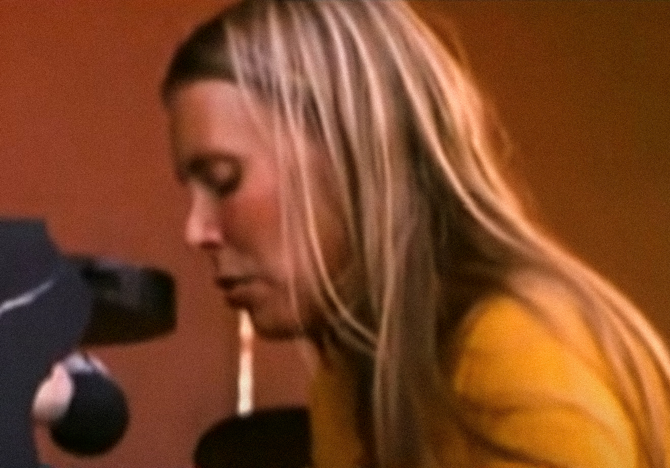 Screenshot: Joni Mitchell is performing on piano with sad face - from Joni Mitchell: A Woman of Heart and Mind (2003)