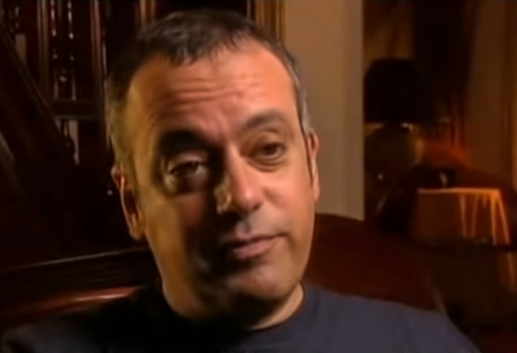 Screenshot: Larry Klein wearing blue sweater is looking sad at camera - from Joni Mitchell: A Woman of Heart and Mind (2003)