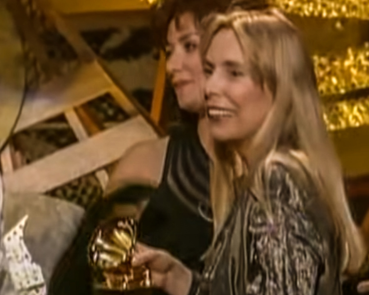 Screenshot: Joni Mitchell wearing black and silver dress is receiving a reward- from Joni Mitchell: A Woman of Heart and Mind (2003)