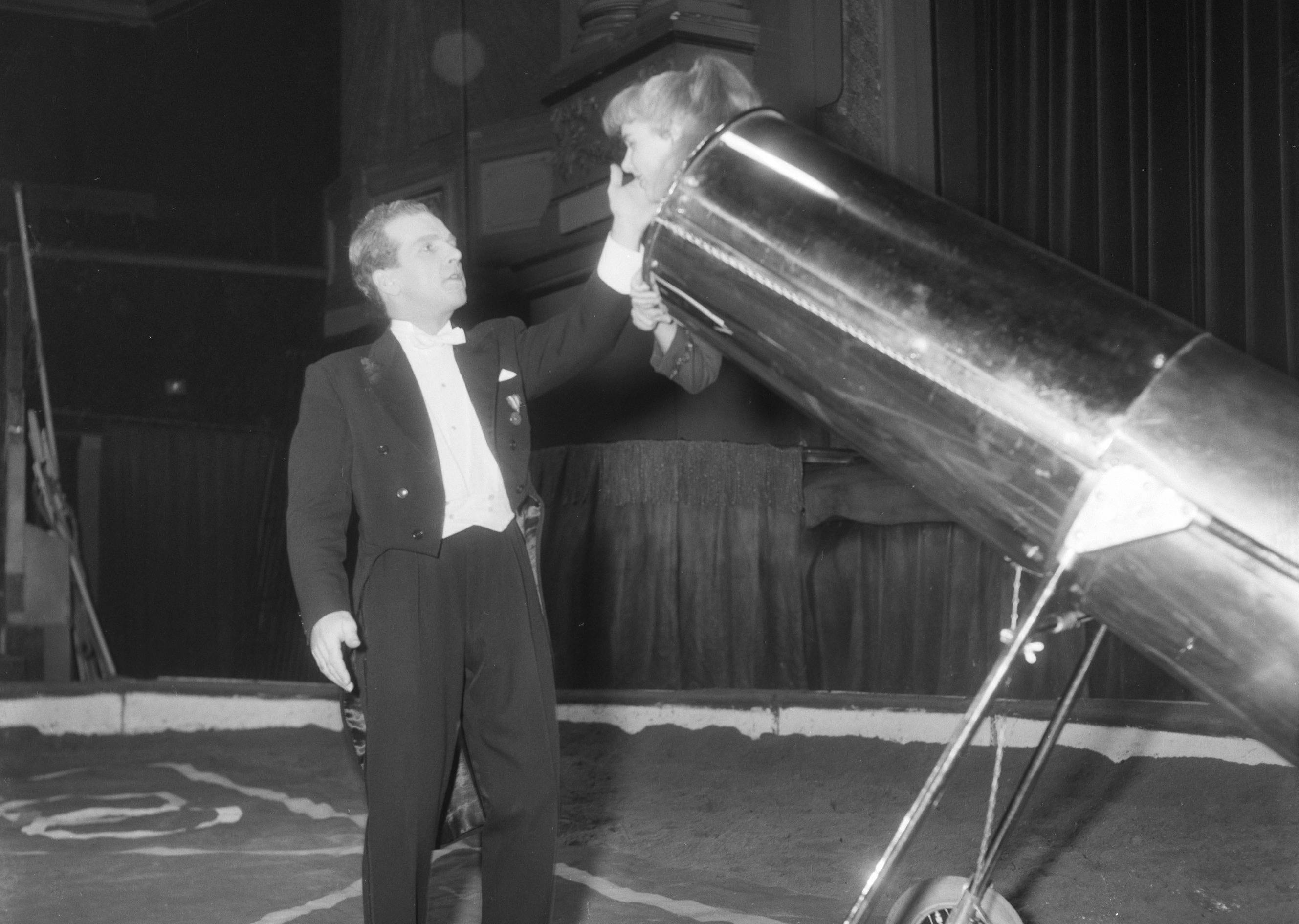 Illusionist Ferry Forst with his cannon, carrying one of his assistants in the air
