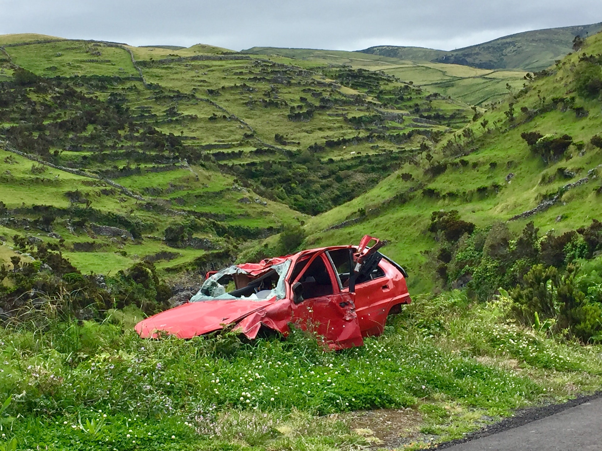Red car accident in a ditch