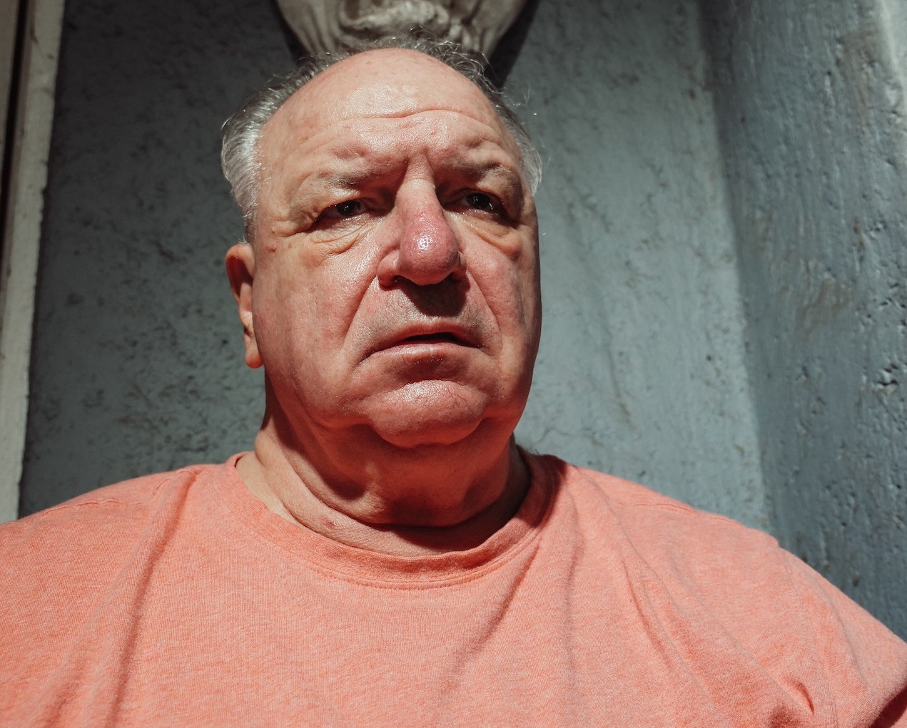 Senior man is looking at front with upset face.