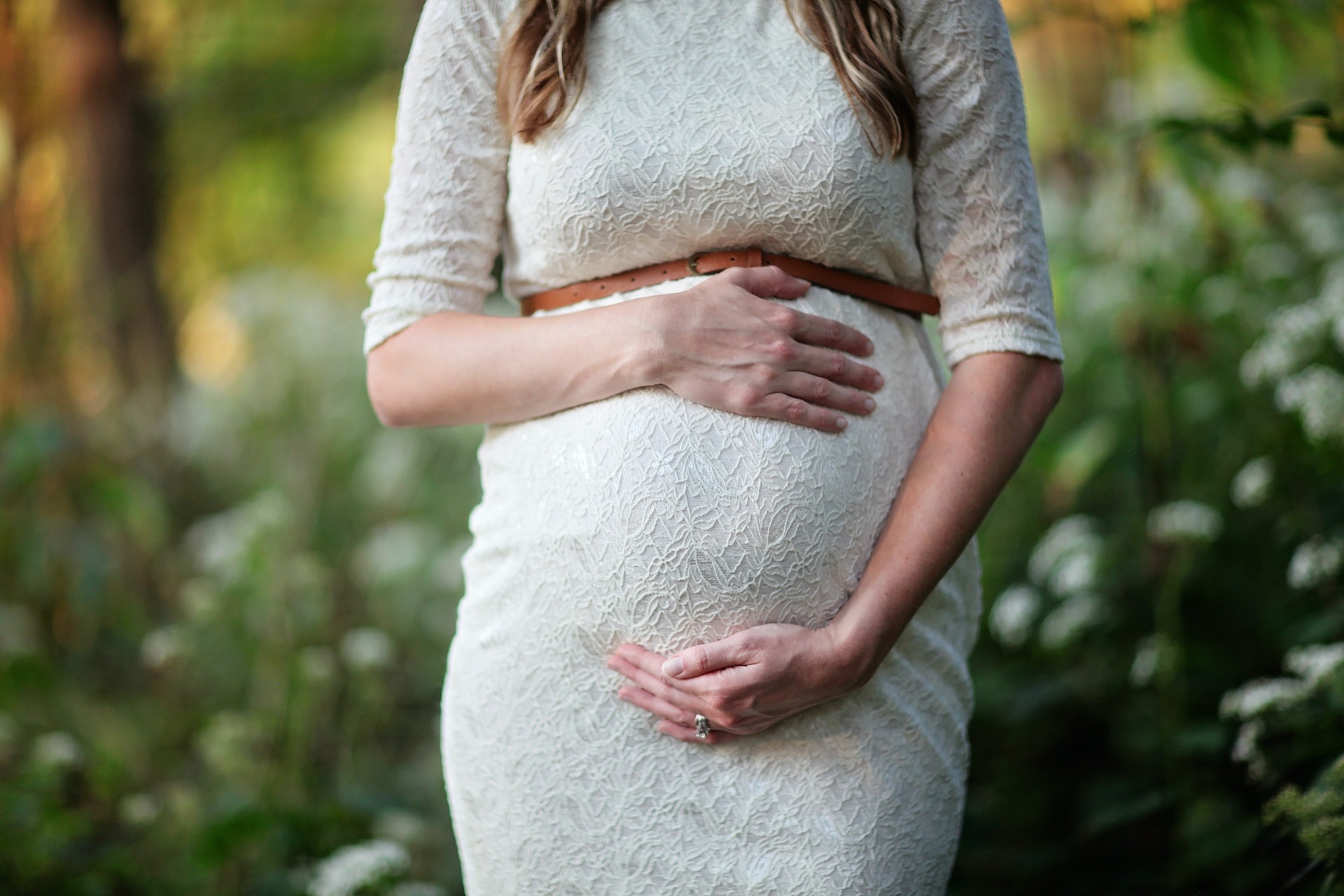 Pregnant woman in white dress
