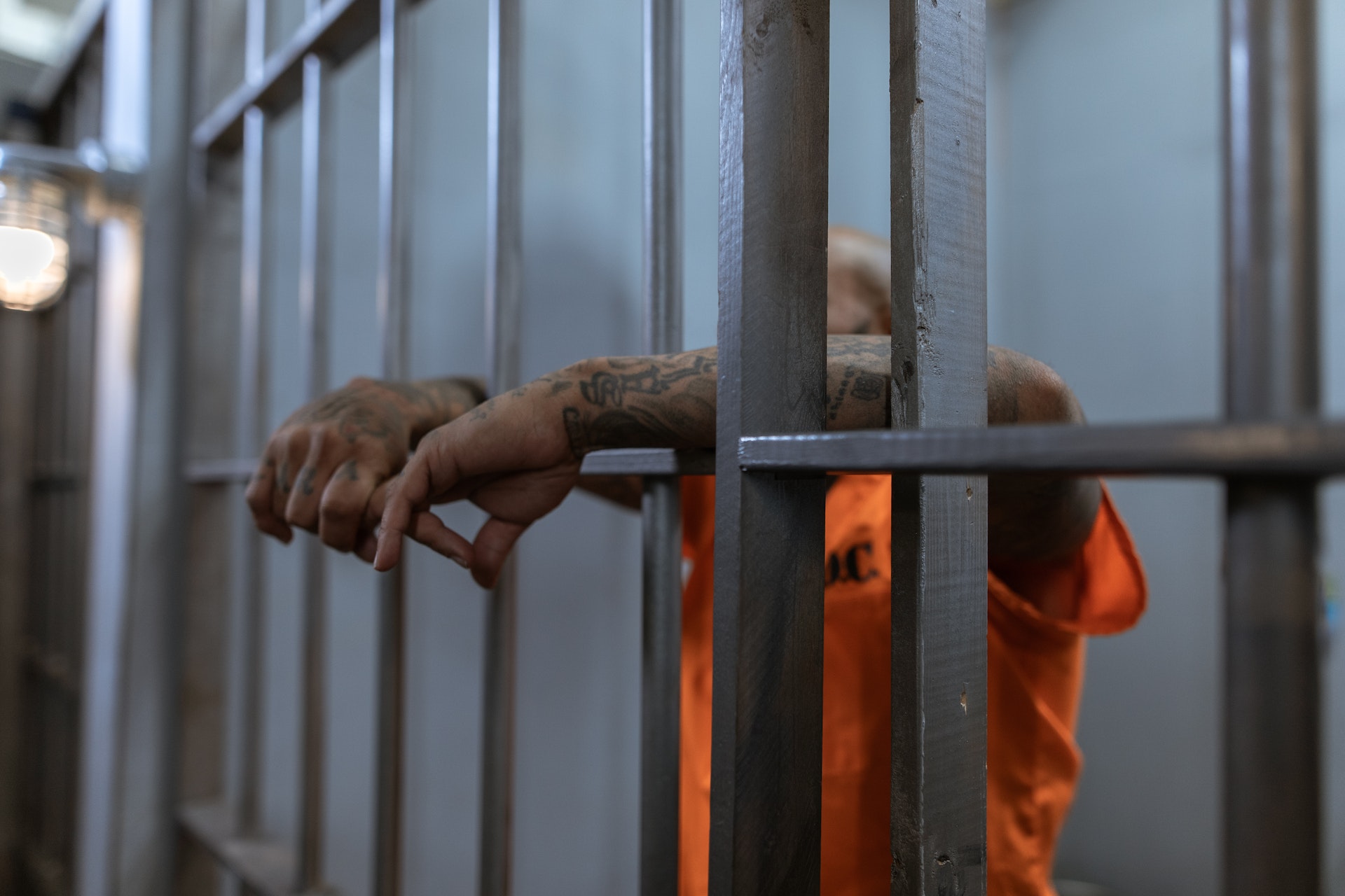 A person in orange shirt in prison