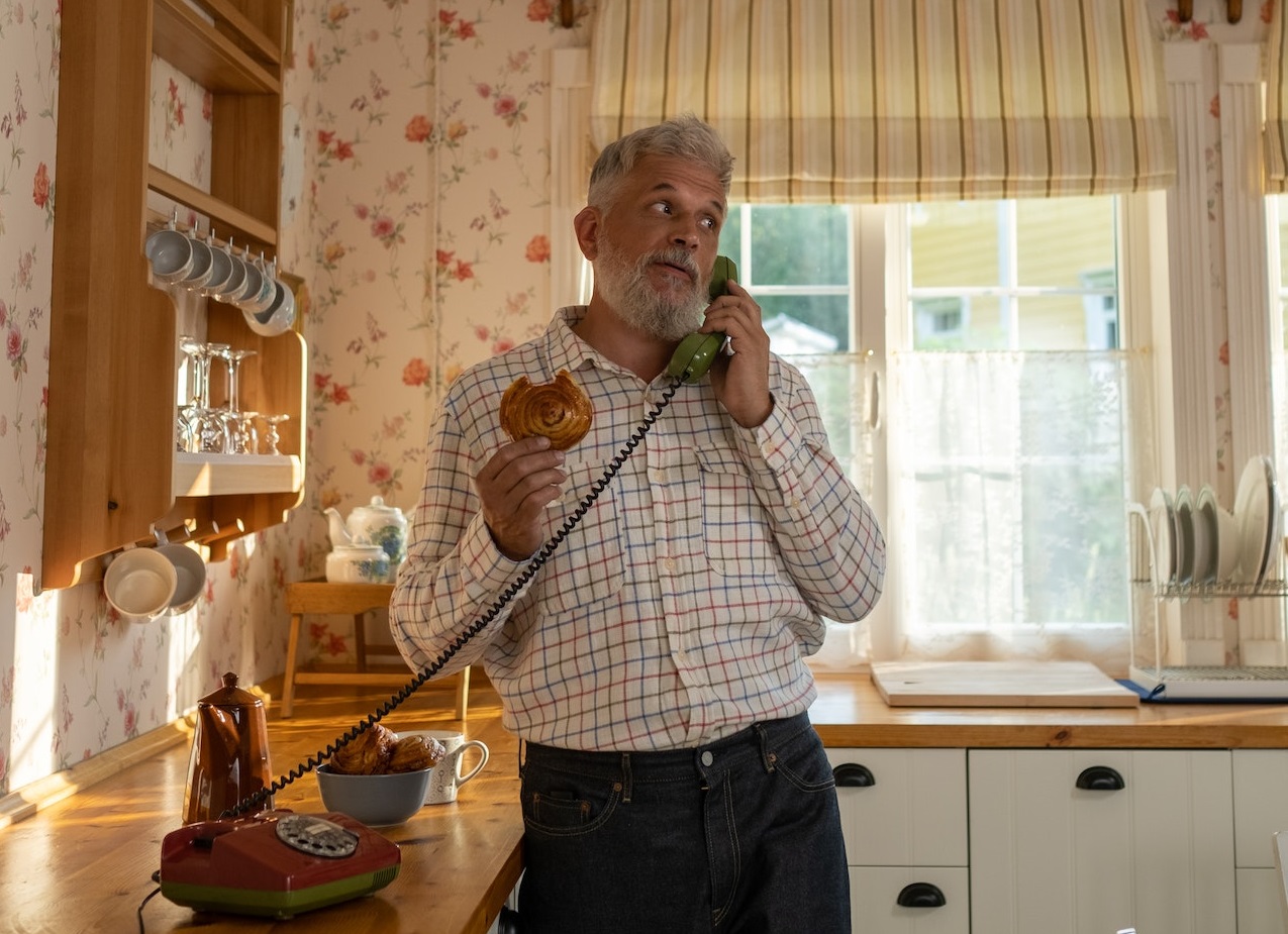 Senior man is talking on telephone and looking at side.