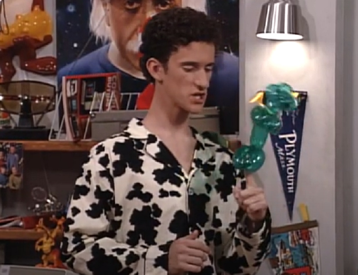 Screenshot: Dustin Diamond is looking at side and holding a balloon - from Saved by the Bell: The College Years (1993-1994)