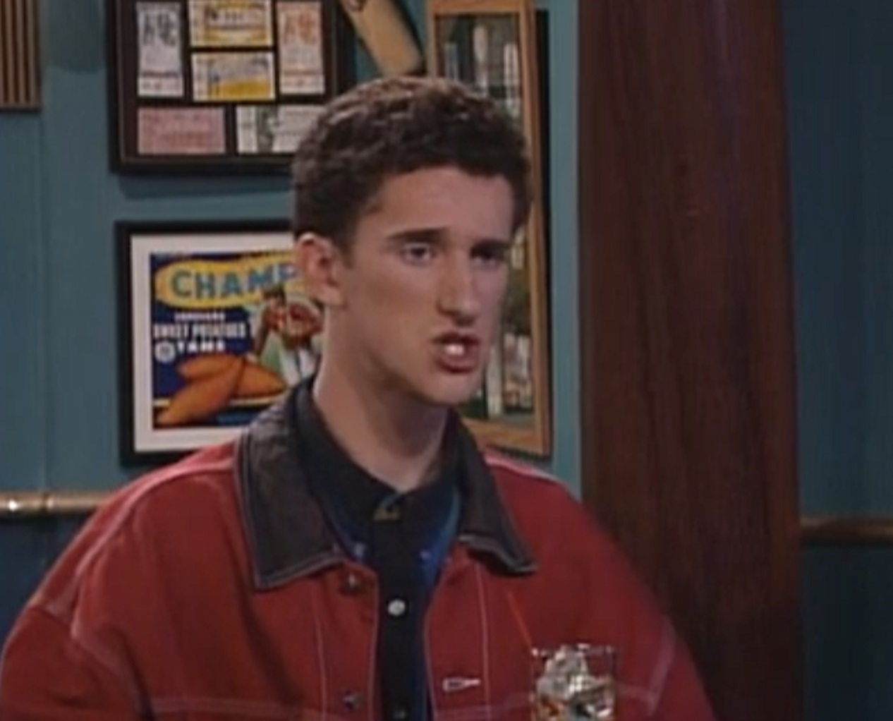 Screenshot: Dustin Diamond wearing red jacket and looking at side - from Saved by the Bell: The College Years (1993-1994)
