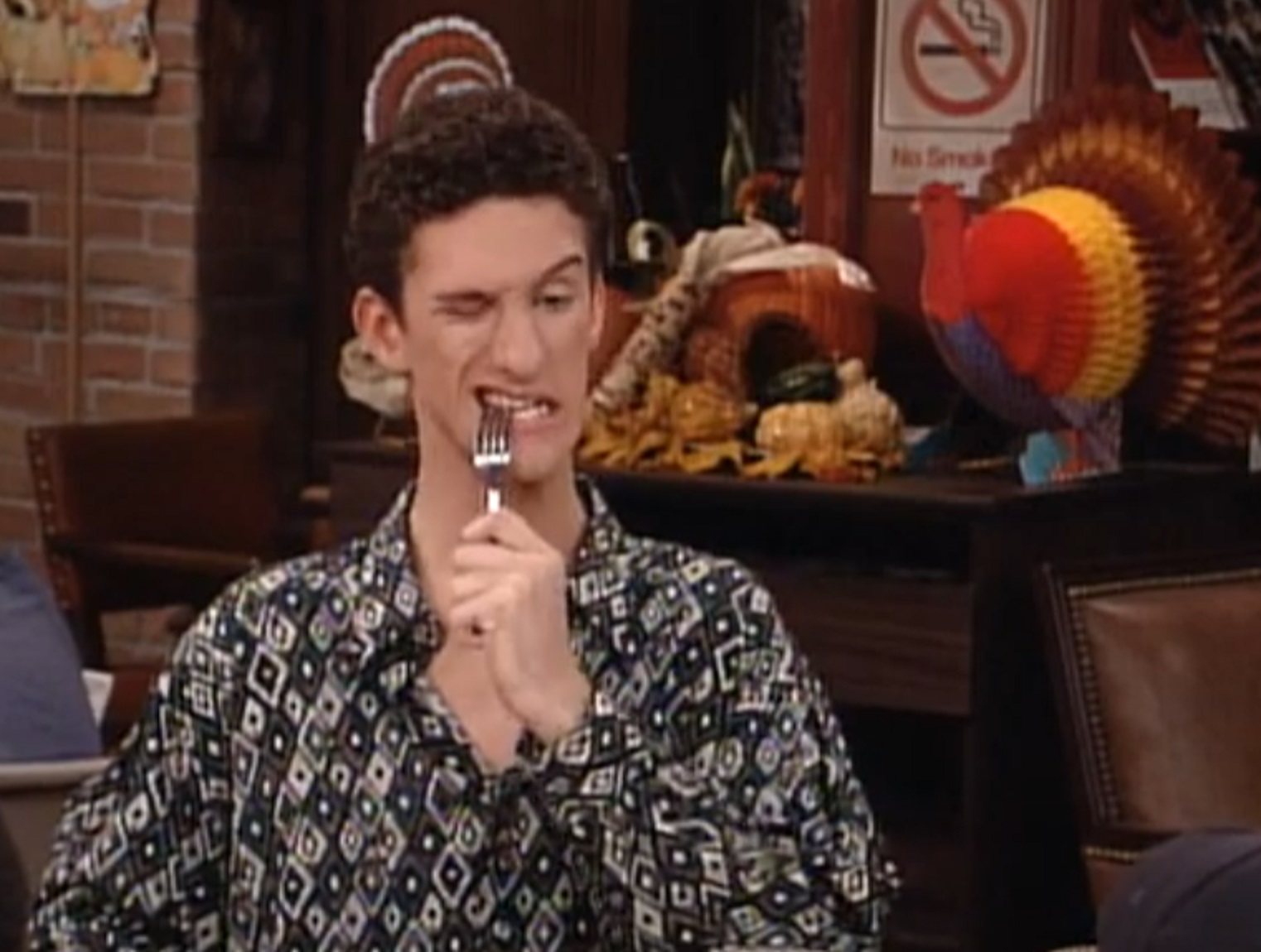 Screenshot: Dustin Diamond is biting a metal fork - from Saved by the Bell: The College Years (1993-1994)