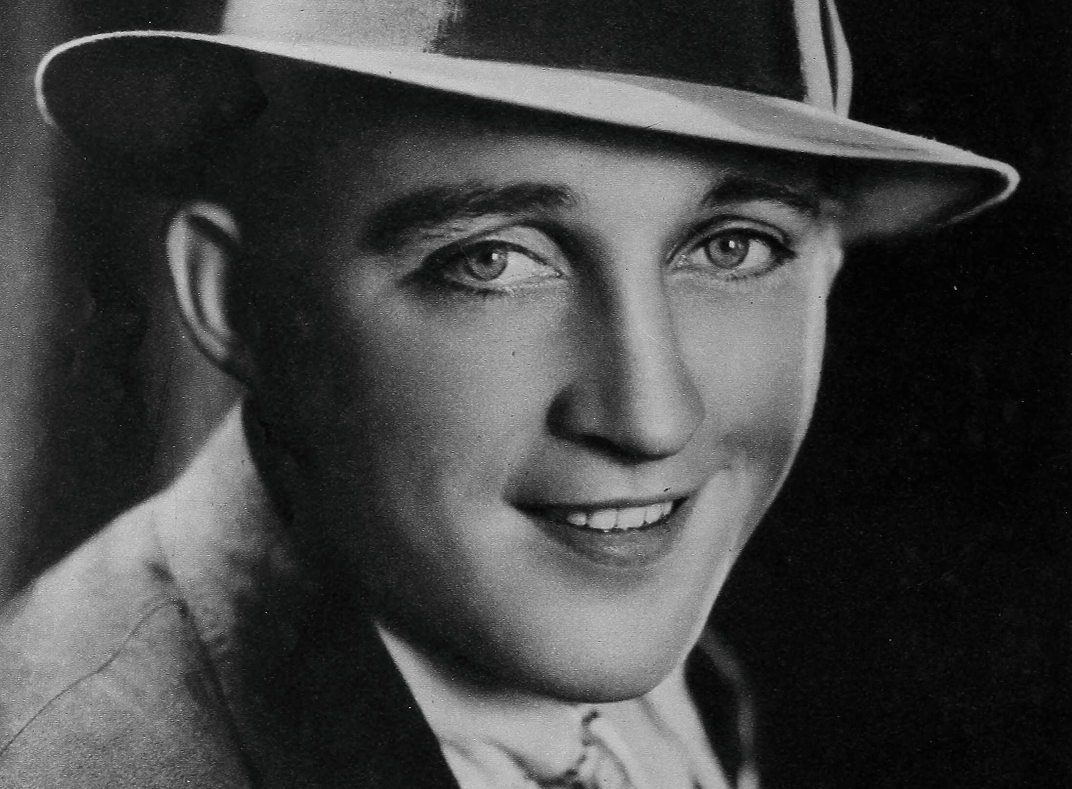 Portrait of Bing Crosby wearing a hat and a suit