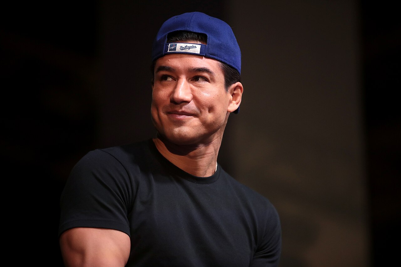 Mario Lopez wearing black shirt and blue hat is looking at side - 2021