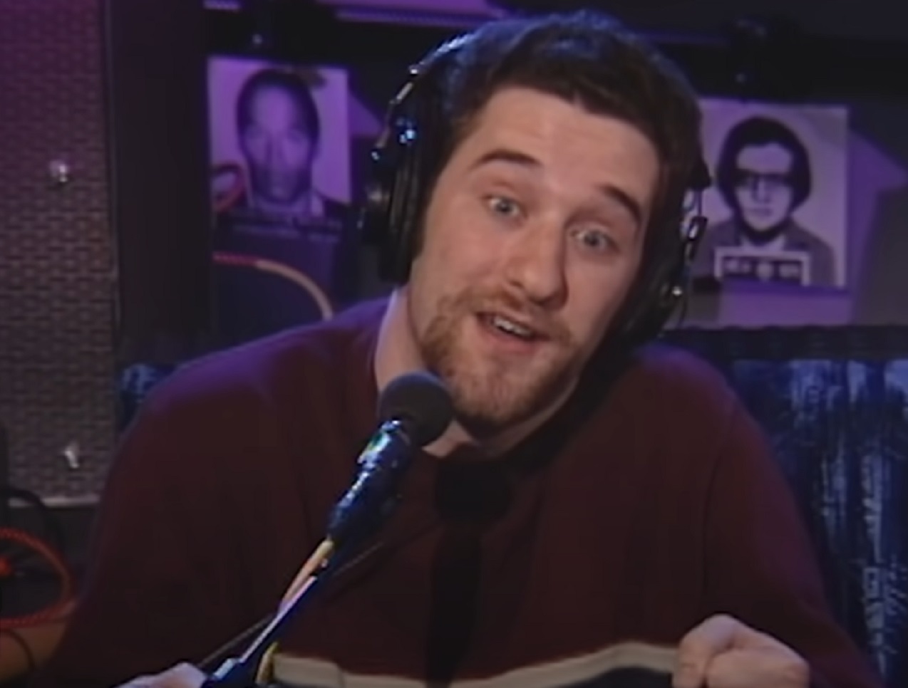 Screenshot: Dustin Diamond is talking on the microphone ,looking surprised - from The Howard Stern Radio Show (1998-2001)