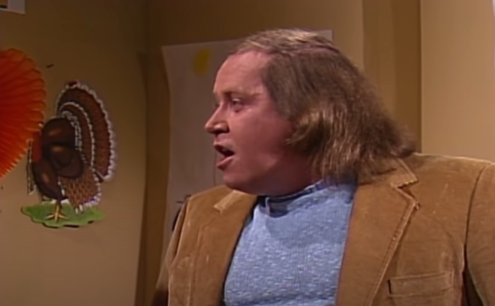 Sam Kinison in SNL wearing brown jacket