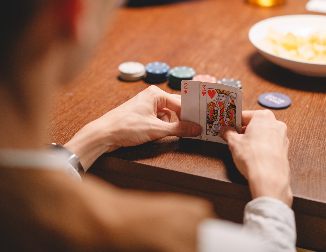 Man holding two cards ,playing card game.