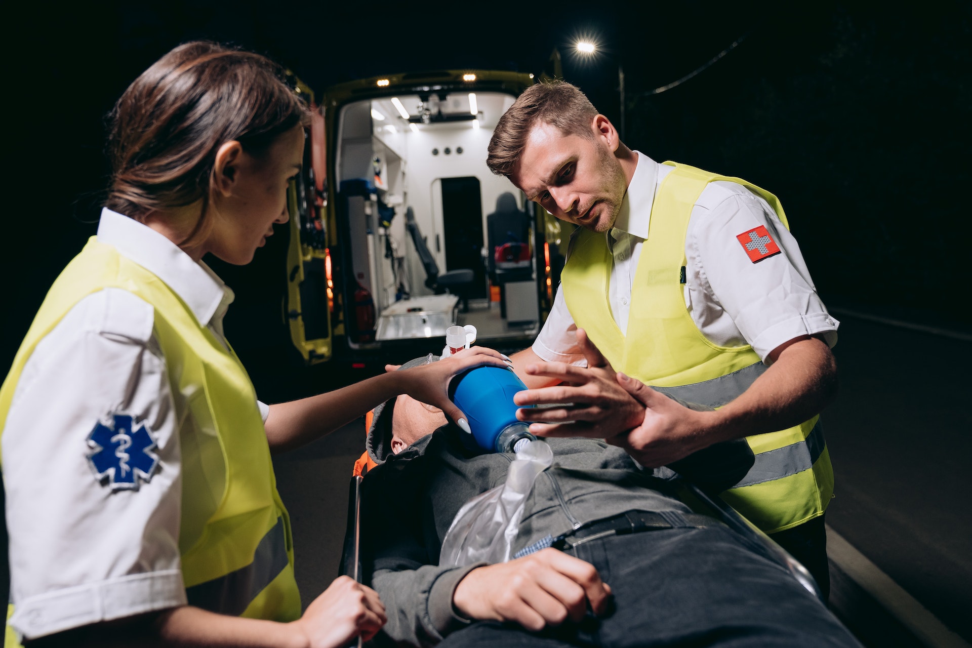 Paramedics giving first aid to a person.