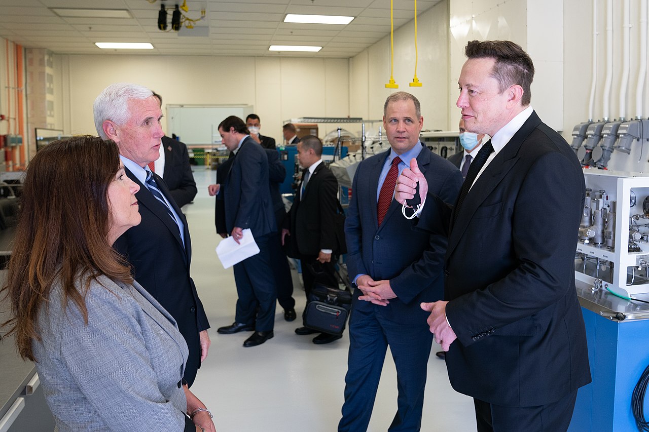 Elon Musk is having a conversation with people in factory  - 2020