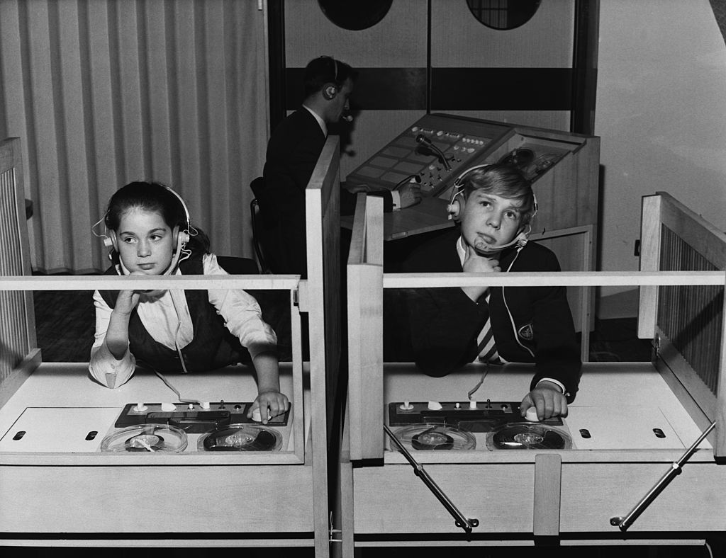 Sharon and David Arden begin to learn French at Britain's first language laboratory in London wearing headphones