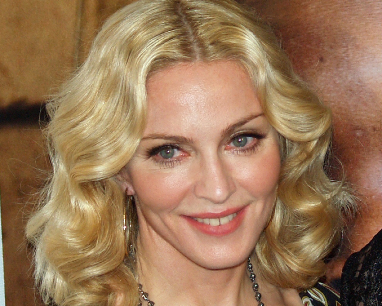 Madonna is looking at side and smiling - 2011