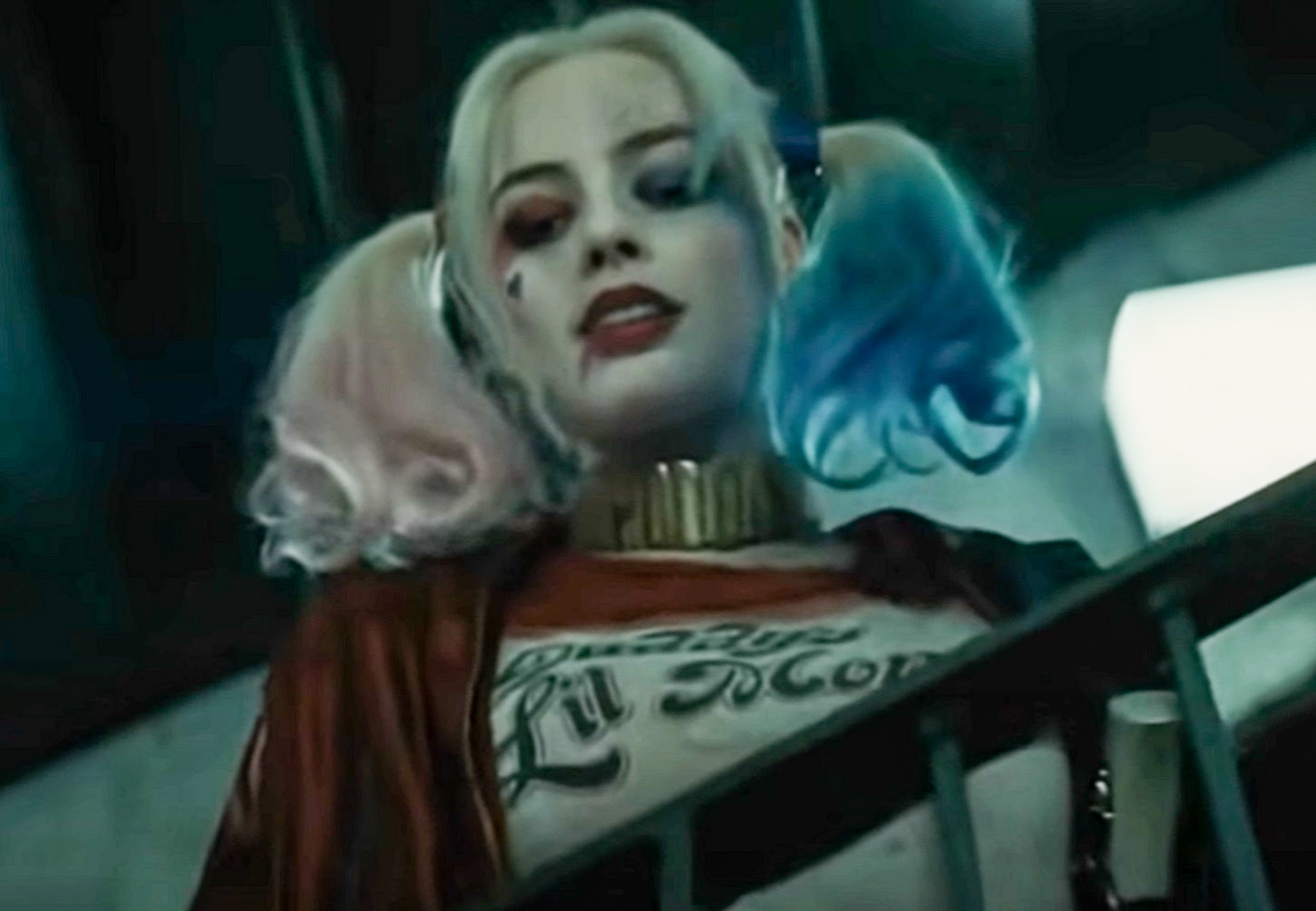 Harley Quinn (Margot Robbie) wearing red shirt looking down - from Suicide Squad (2016)