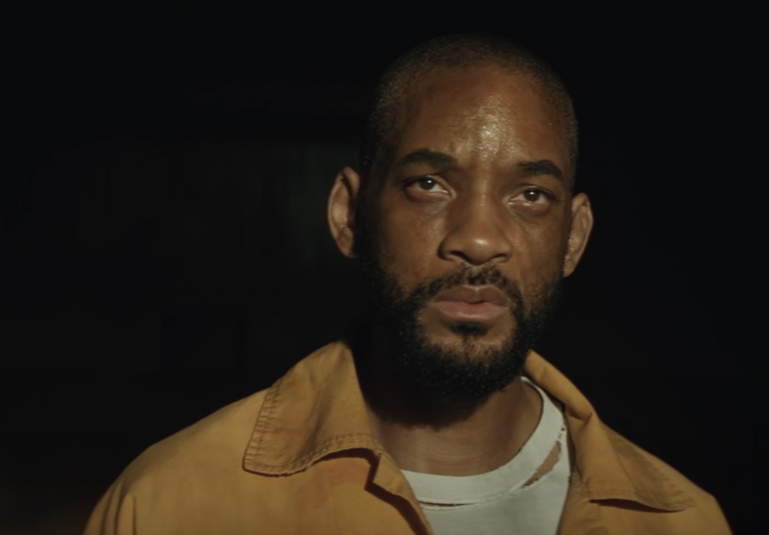 Screenshot: Deadshot (Will Smith) wearing beige jacket is looking at side - from Suicide Squad (2016)