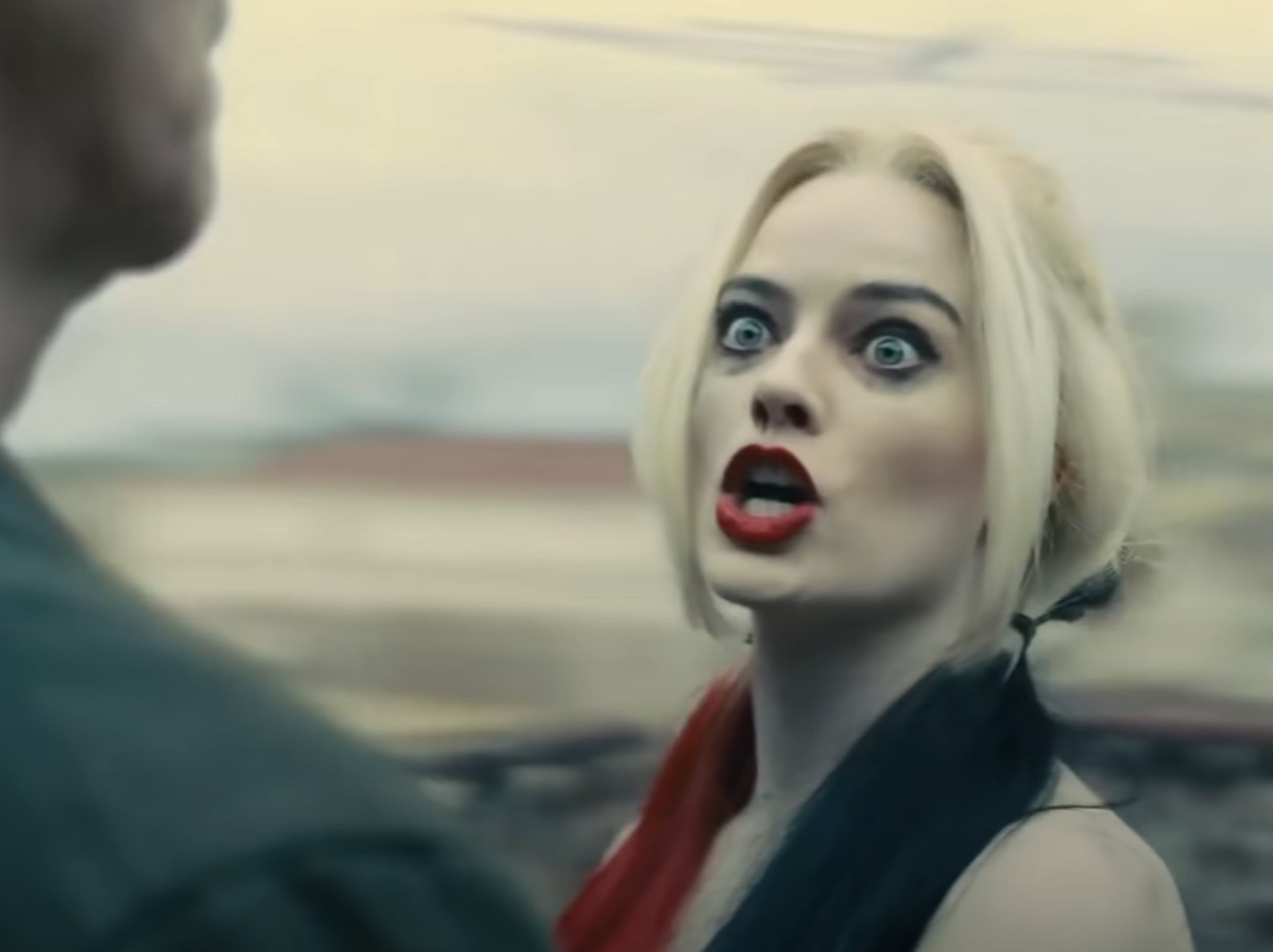 Screenshot: Harley Quinn (Margot Robbie) is yelling and looking at other person with angry face - from The Suicide Squad (2021)