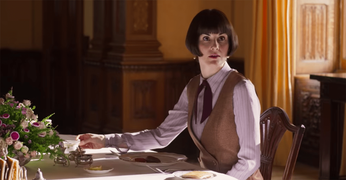 Lady Mary Crawley sitting at a table having dinner 