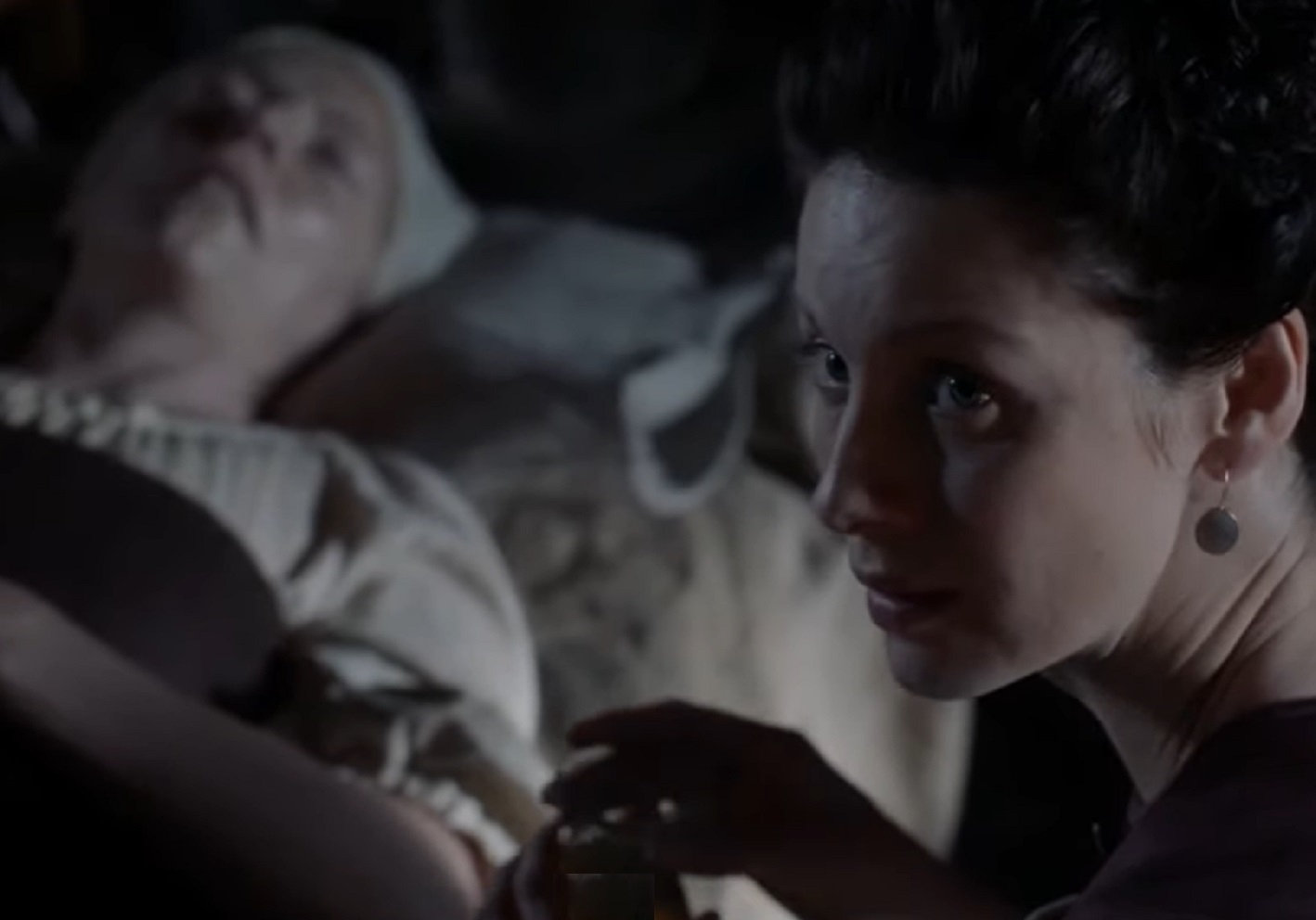 Screenshot: Claire Fraser is standing by the patient's bed - from Outlander (Tv Series)