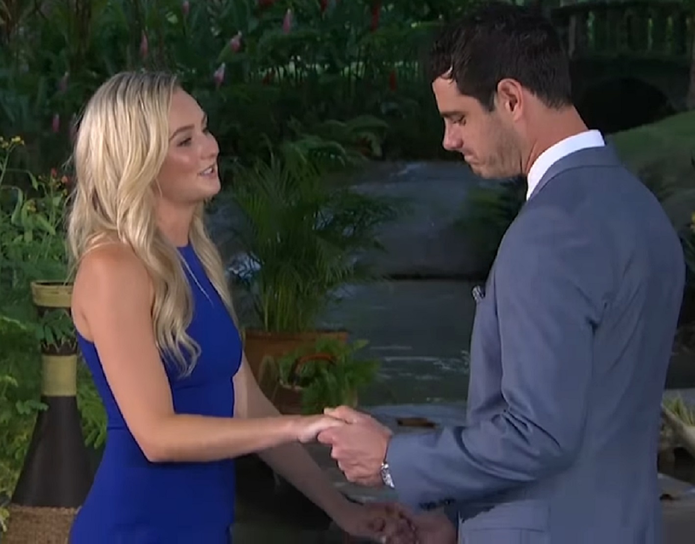 Screenshot: Higgins and Bushnell talking and holding hand outside - from The Bachelor (American TV series)