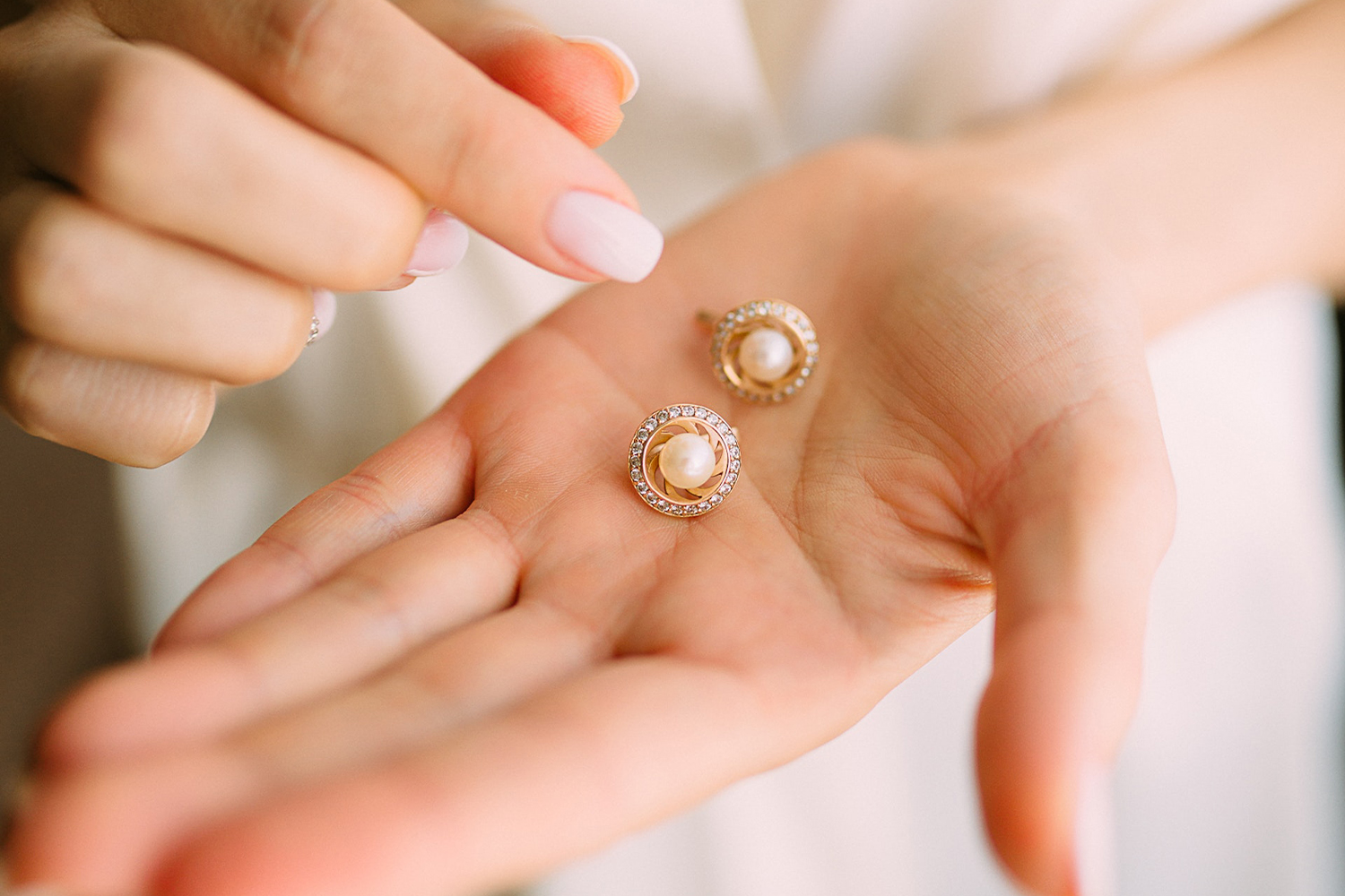 Hands Holding Earrings
