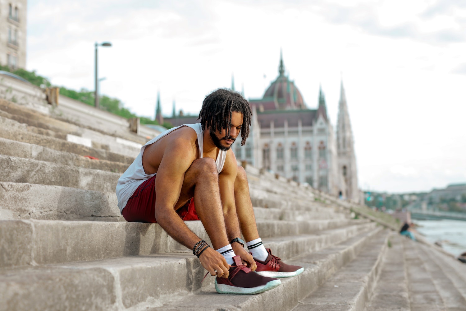 Man Tying His Shoes On Some Steps