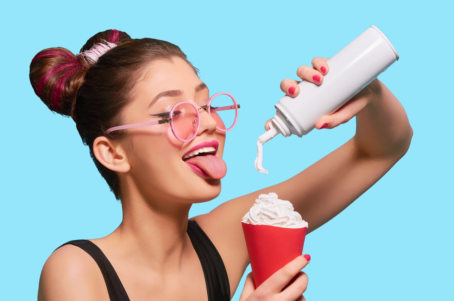 Young woman is holding a whipped cream in her hands.