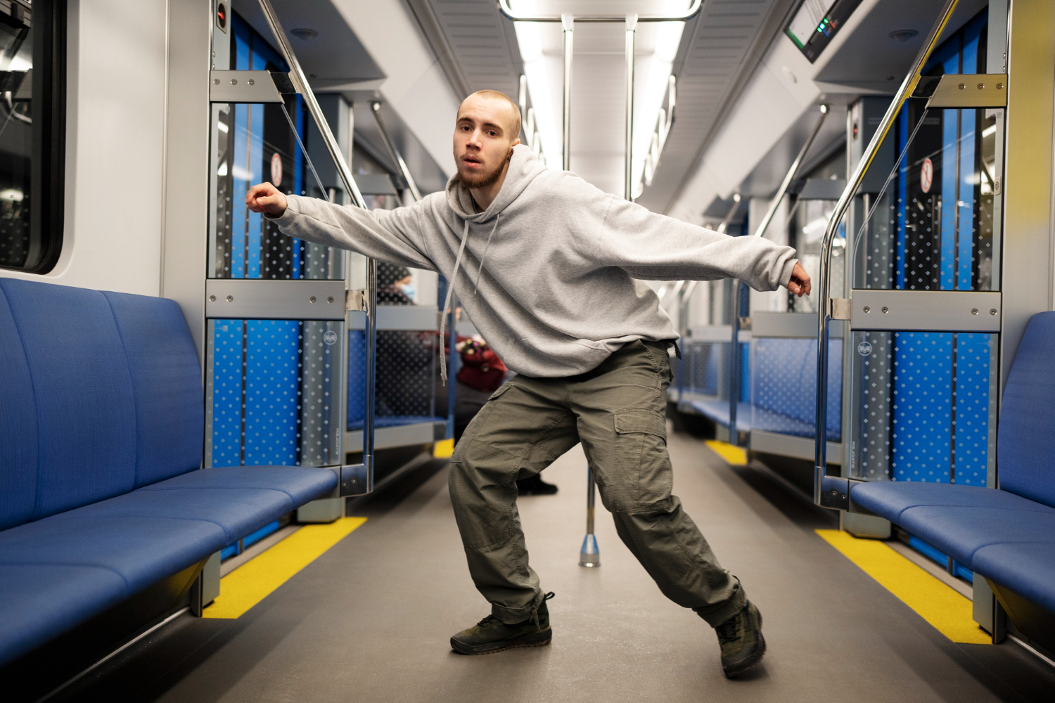 Young man is dancing on the train.