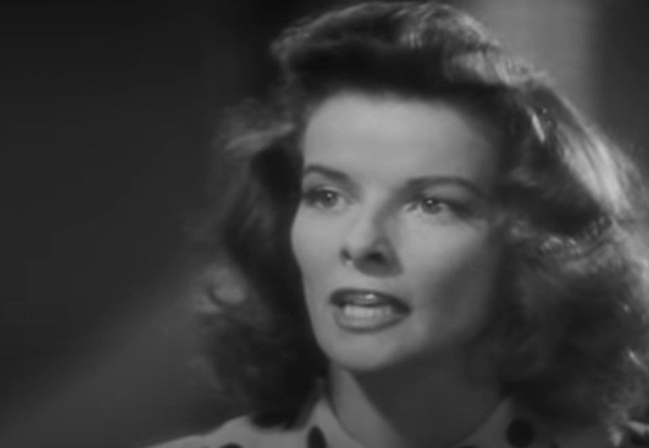 Katharine Hepburn as Tess Harding in spotted top speaking to someone