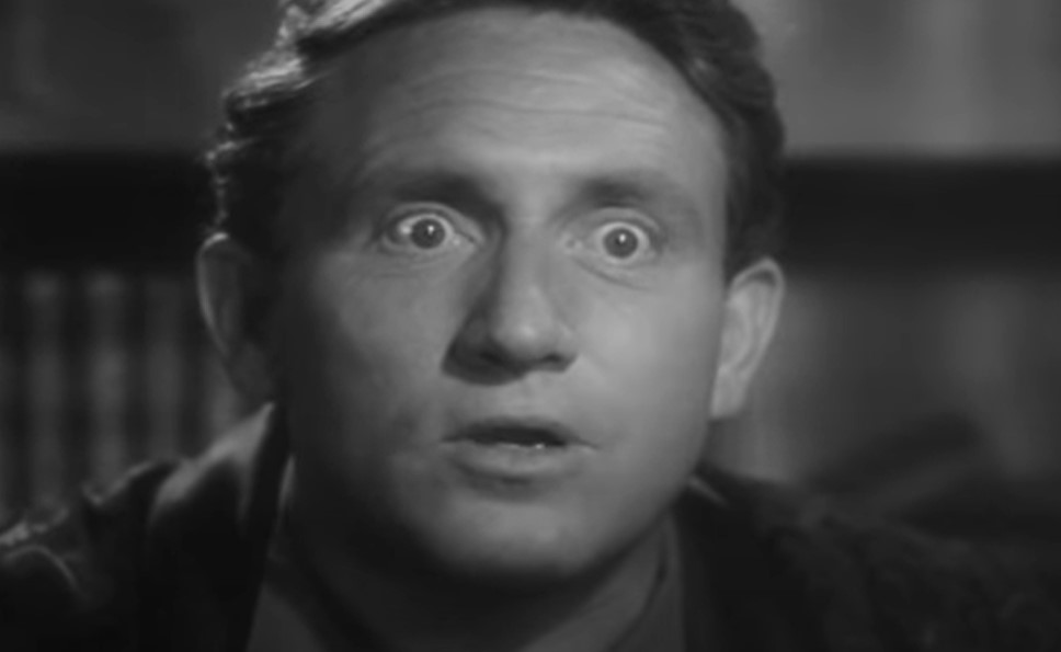 Spencer Tracy as Sam Craig in suit looking shocked