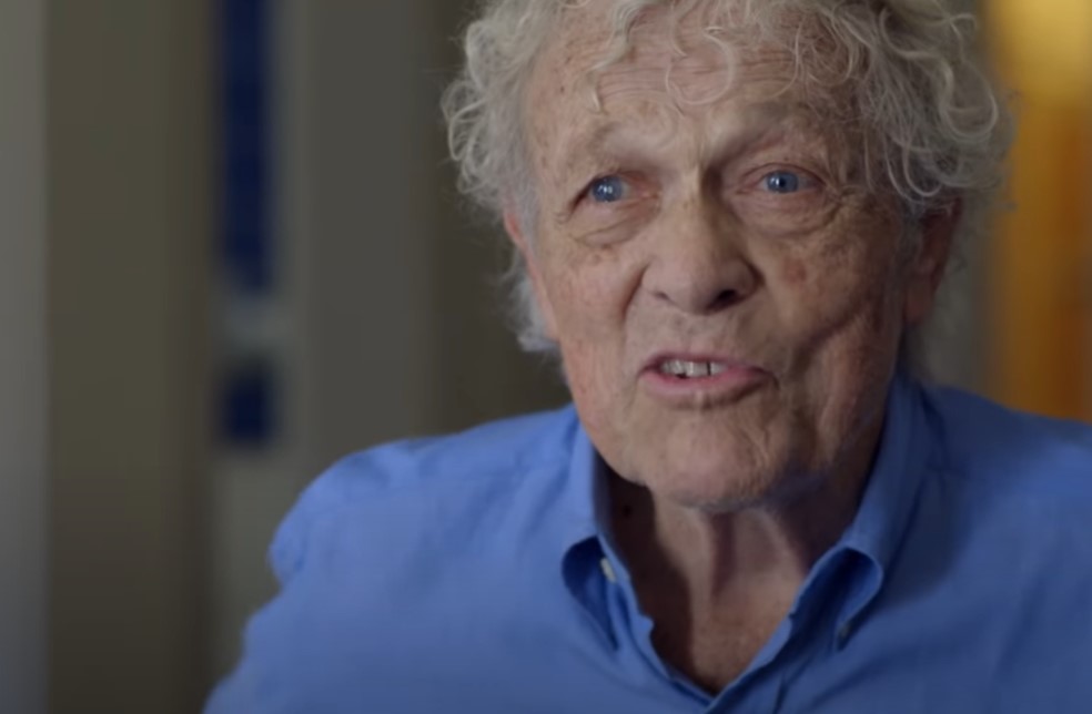 Scotty Bowers in blue shirt looking at the camera