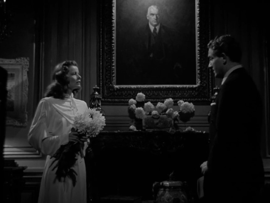 Tracy and Hepburn in Keeper of the Flame at home in front of a portrait