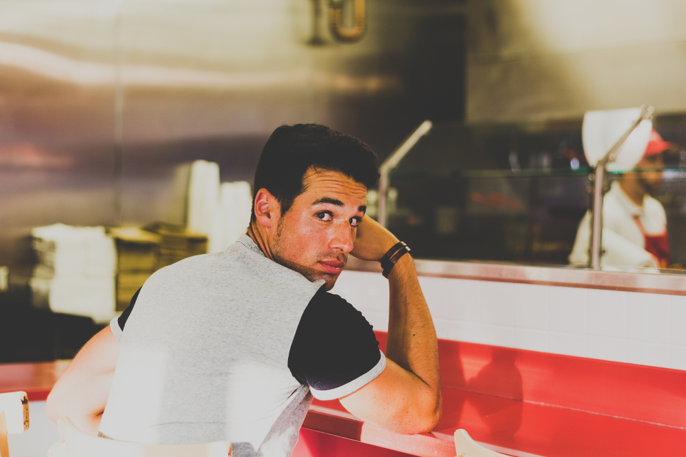 man waiting at local burger restaurant