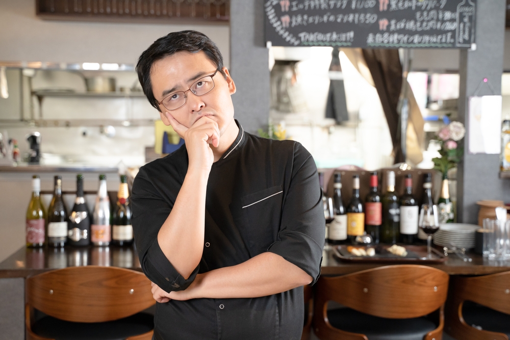 Shocked and confused employee in a restaurant wearing an uniform