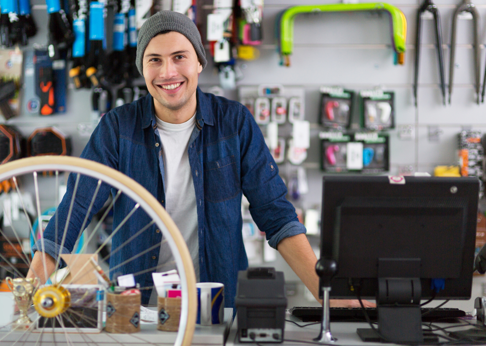 Salesman in bicycle shop wearing denim shirt