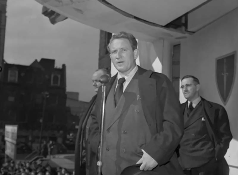 Spencer Tracy speaking at City Hall, Toronto, Ontario, Canada in suit