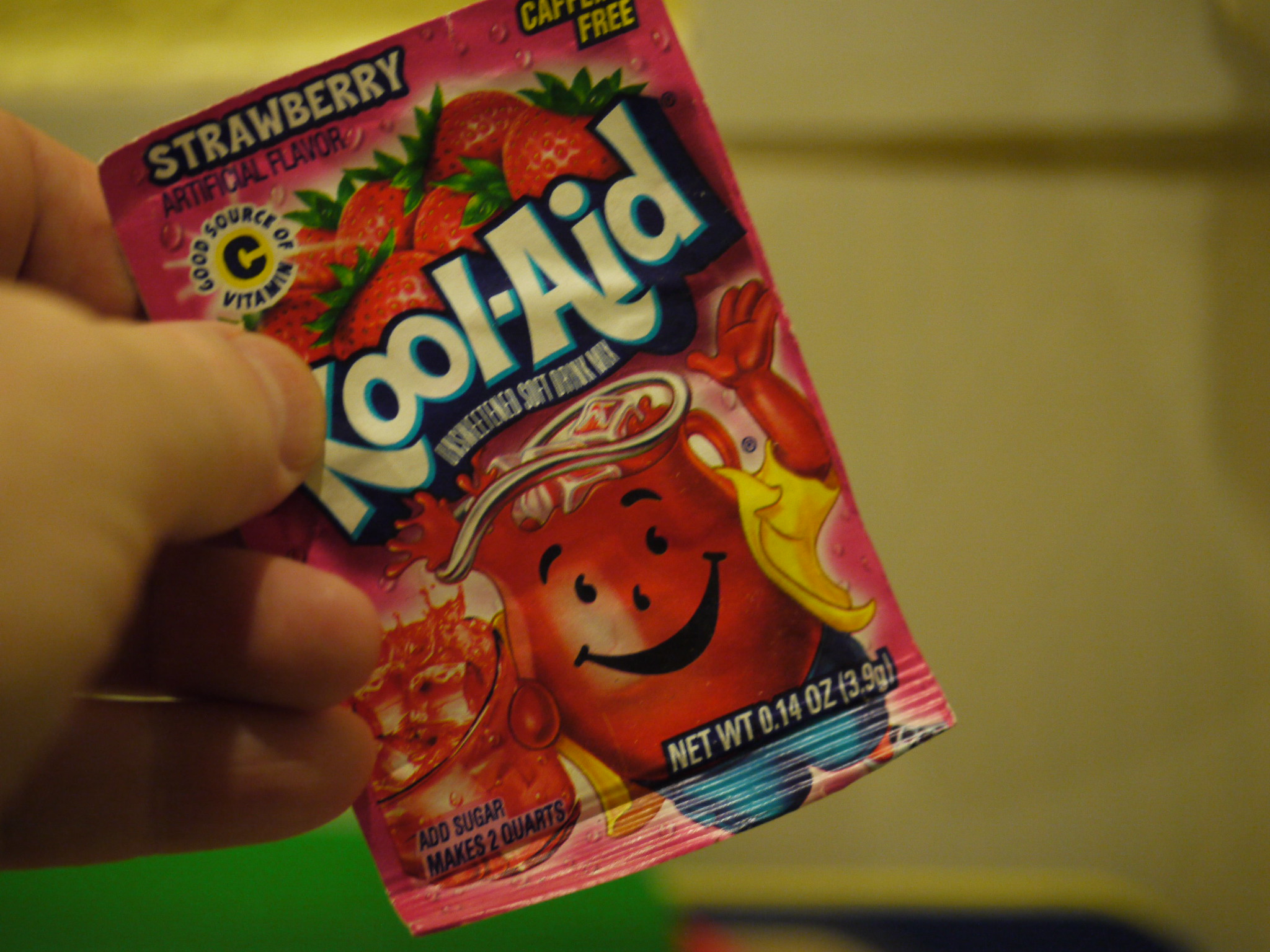 Person holding Kool-Aid packet
