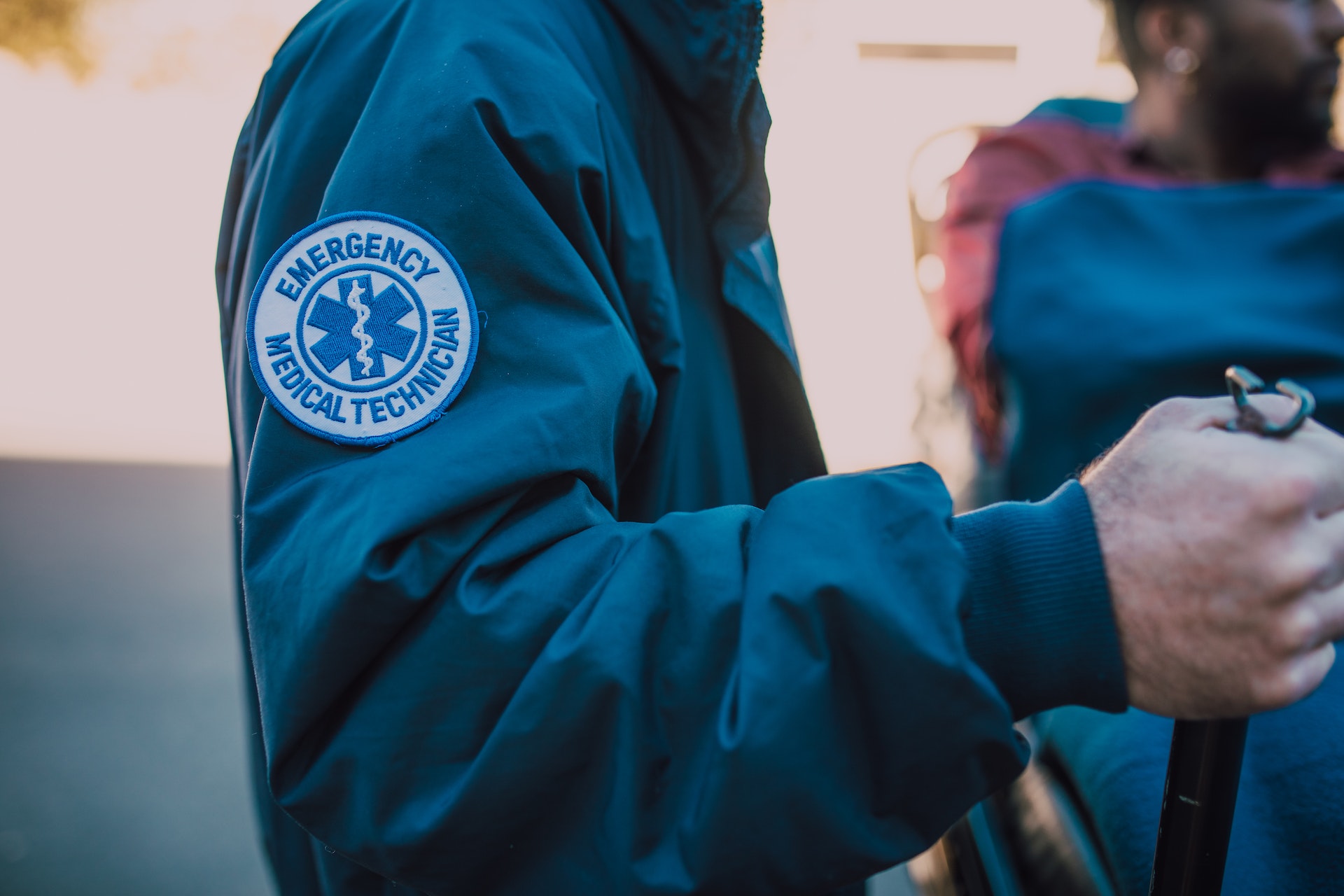Paramedic wearing blue jacket
