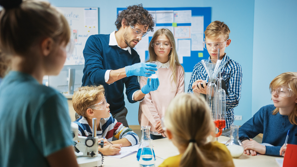Enthusiastic chemistry Teacher Explains Chemistry to Diverse Group of Children