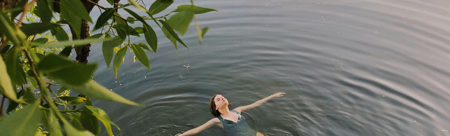 Woman Swimming In A Lake
