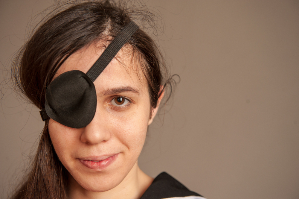 Girl in black top wearing eye patch