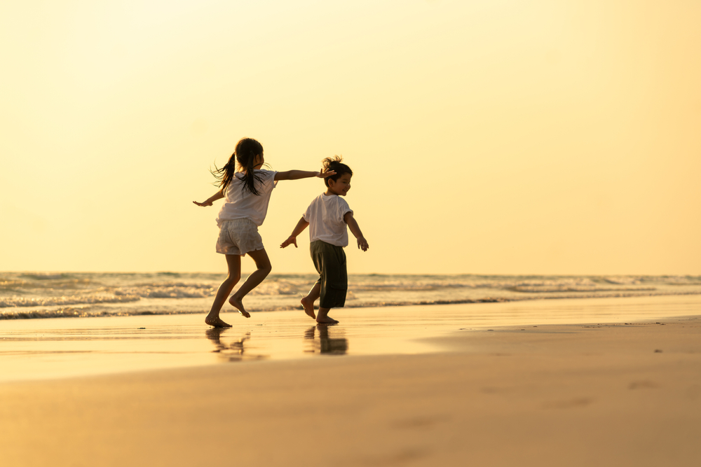 Two kids playing at the beach