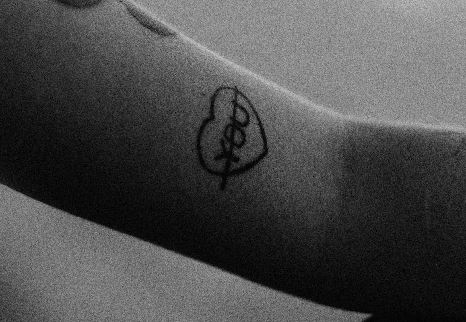 Black and white photography of a heart tattoo